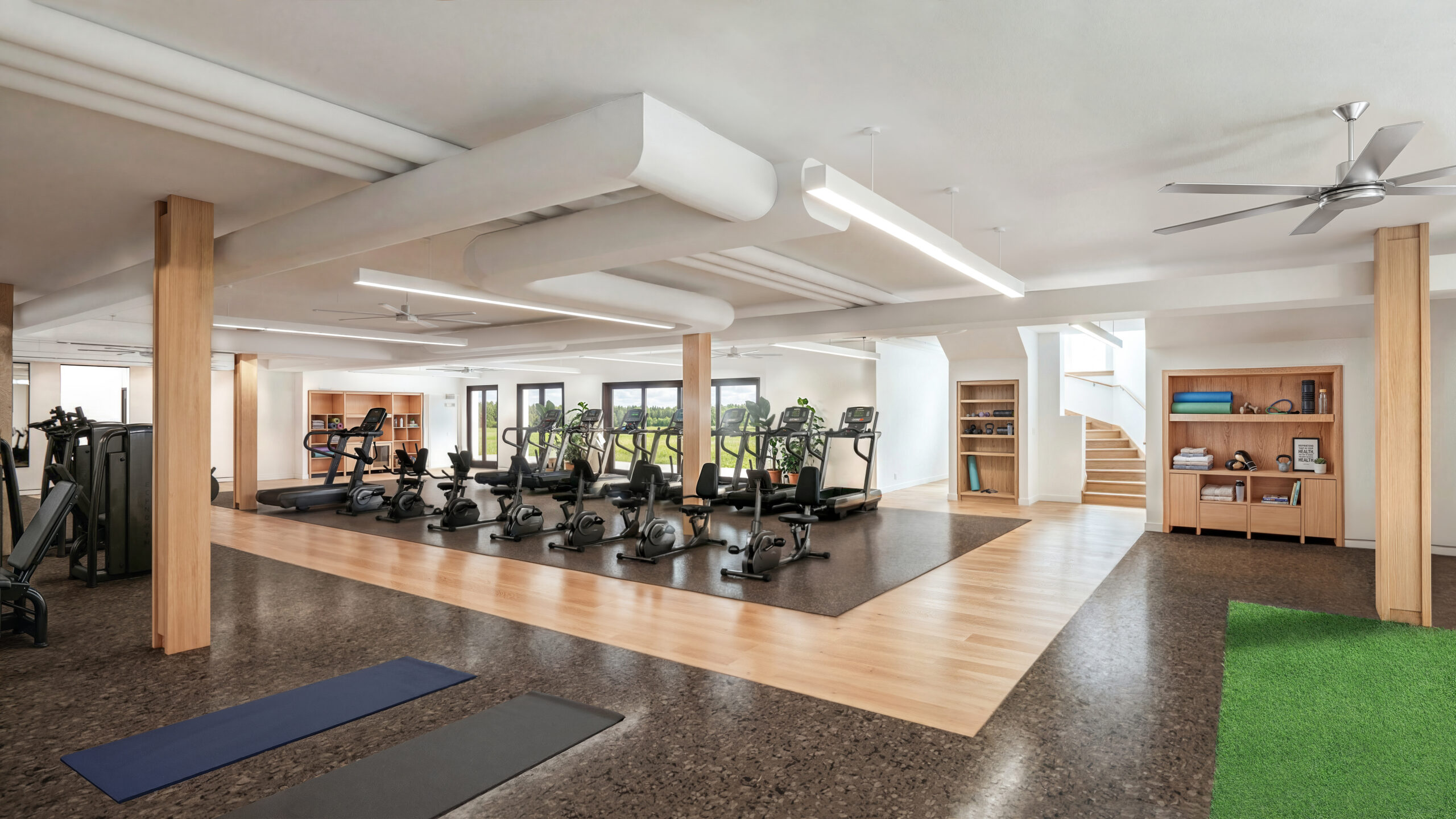 Spacious fitness center with treadmills, stationary bikes, strength machines, and natural wood accents.