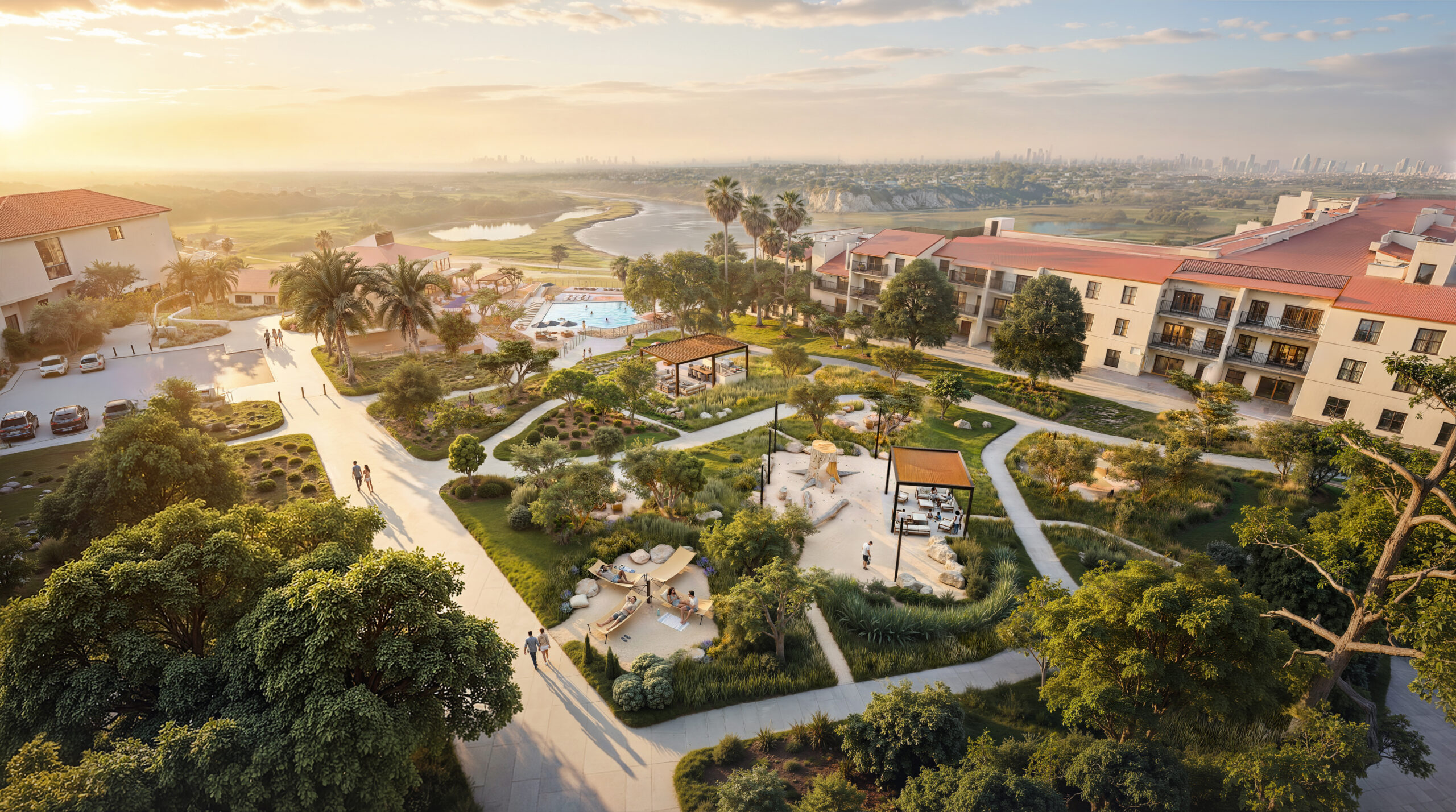 Aerial rendering of Park Newport's The Ramble outdoor green space at sunset featuring winding pathways, a central pergola, lush native landscaping, mature trees, and apartment buildings with ocean views in the distance