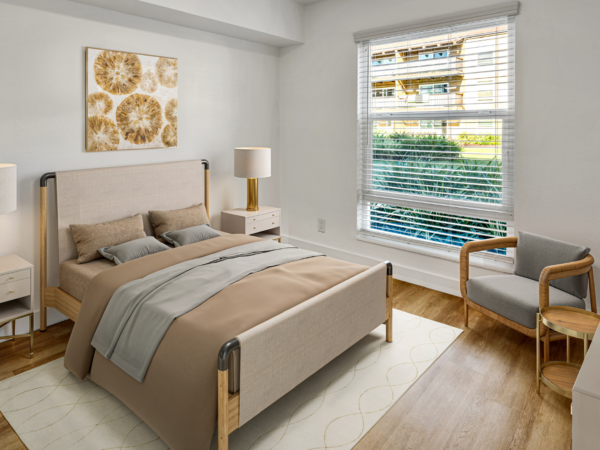 Bright bedroom with upholstered bed, nightstands, lamps, and large window overlooking greenery.