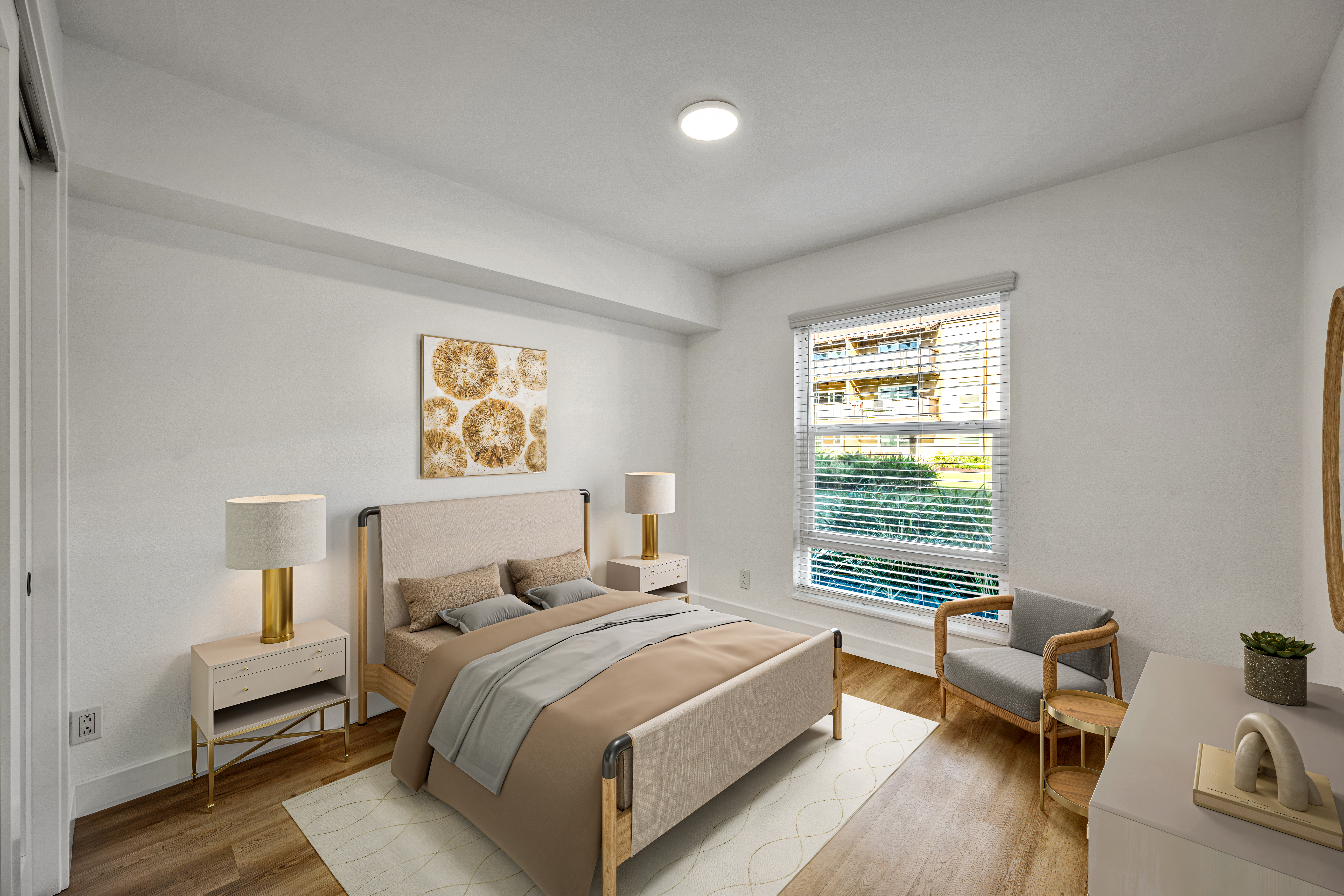 Bright bedroom with upholstered bed, nightstands, lamps, and large window overlooking greenery.