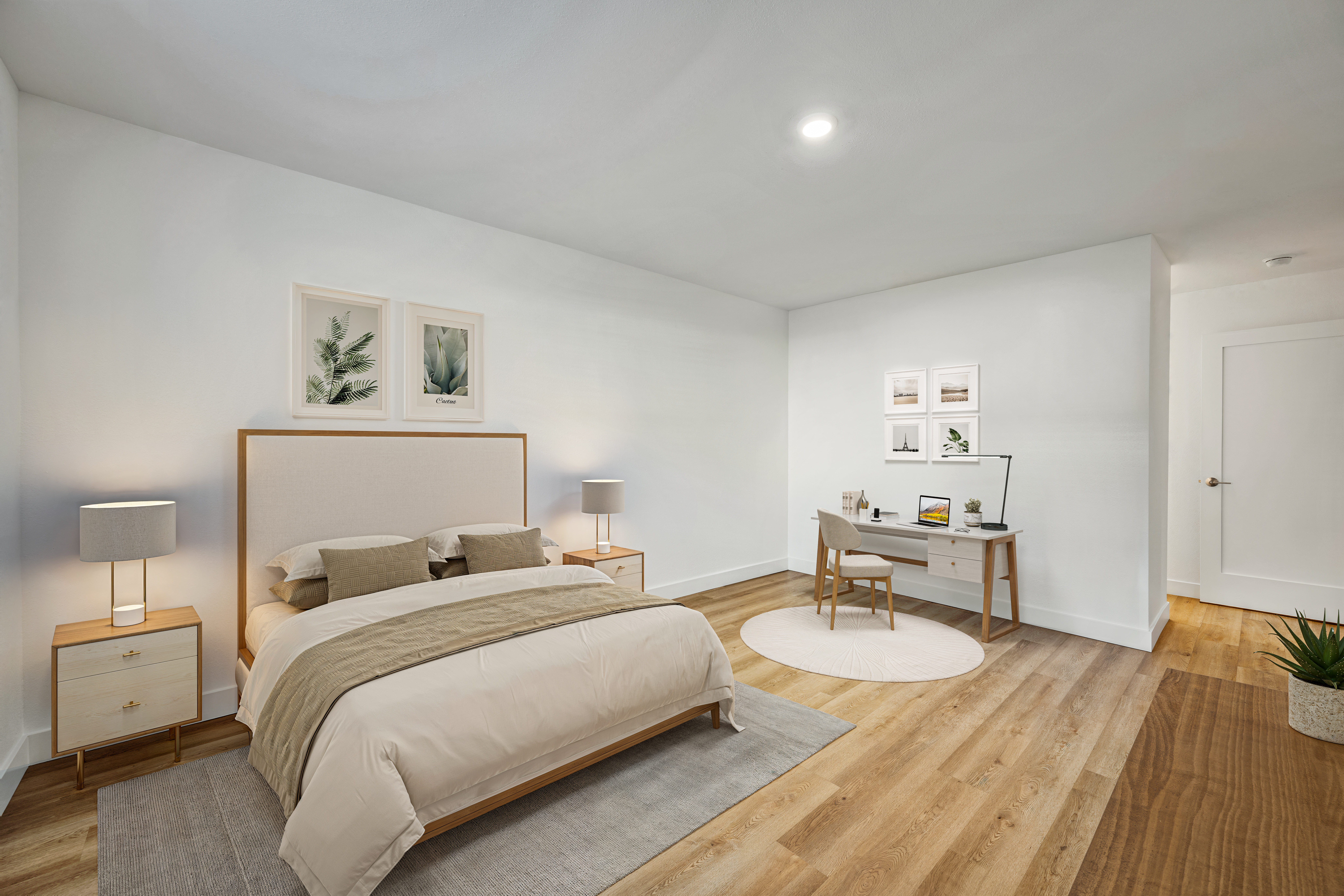 Bright bedroom with upholstered bed, nightstands, lamps, and a desk.